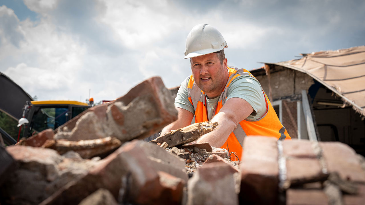 Medewerker met helm en veiligheidshes bij sloopwerk – circulair slopen als duurzame standaard in Nederland