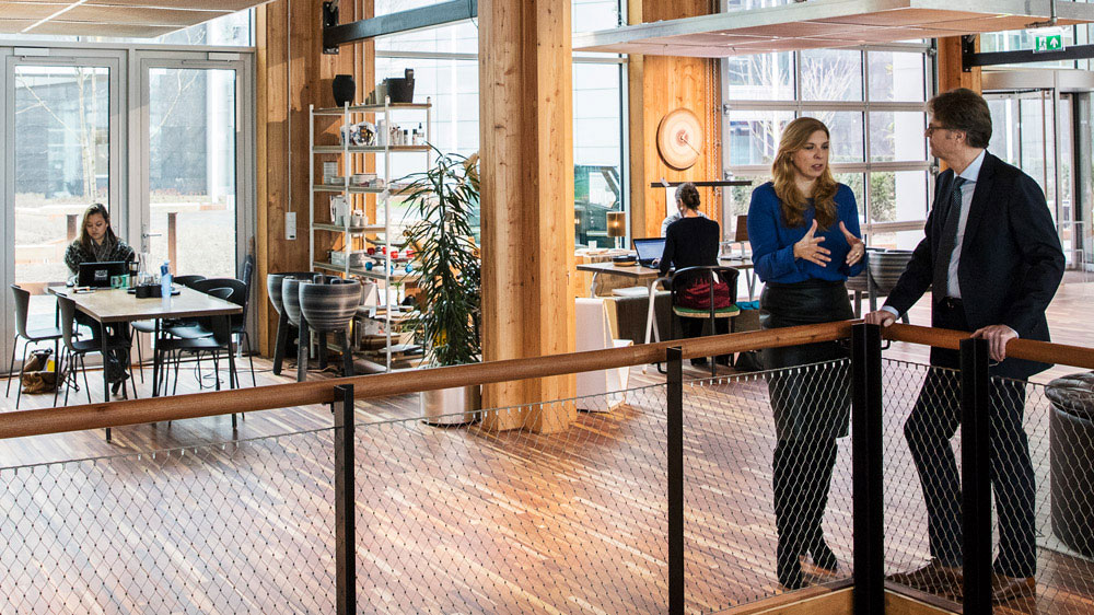 Open kantoorruimte met mensen aan het werk, illustratief voor professioneel advies over energiebesparing en vastgoedbeheer.