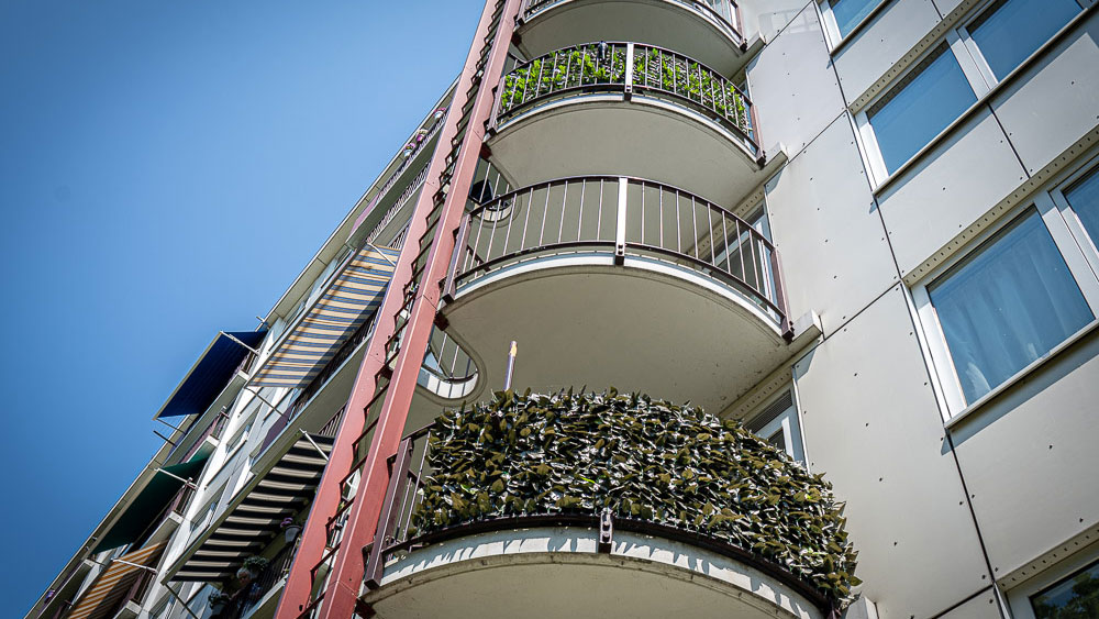 Moderne woongebouw met balkons en groen, onderdeel van Tetra Tech-project voor brandveiligheid en duurzame gebouwinspectie